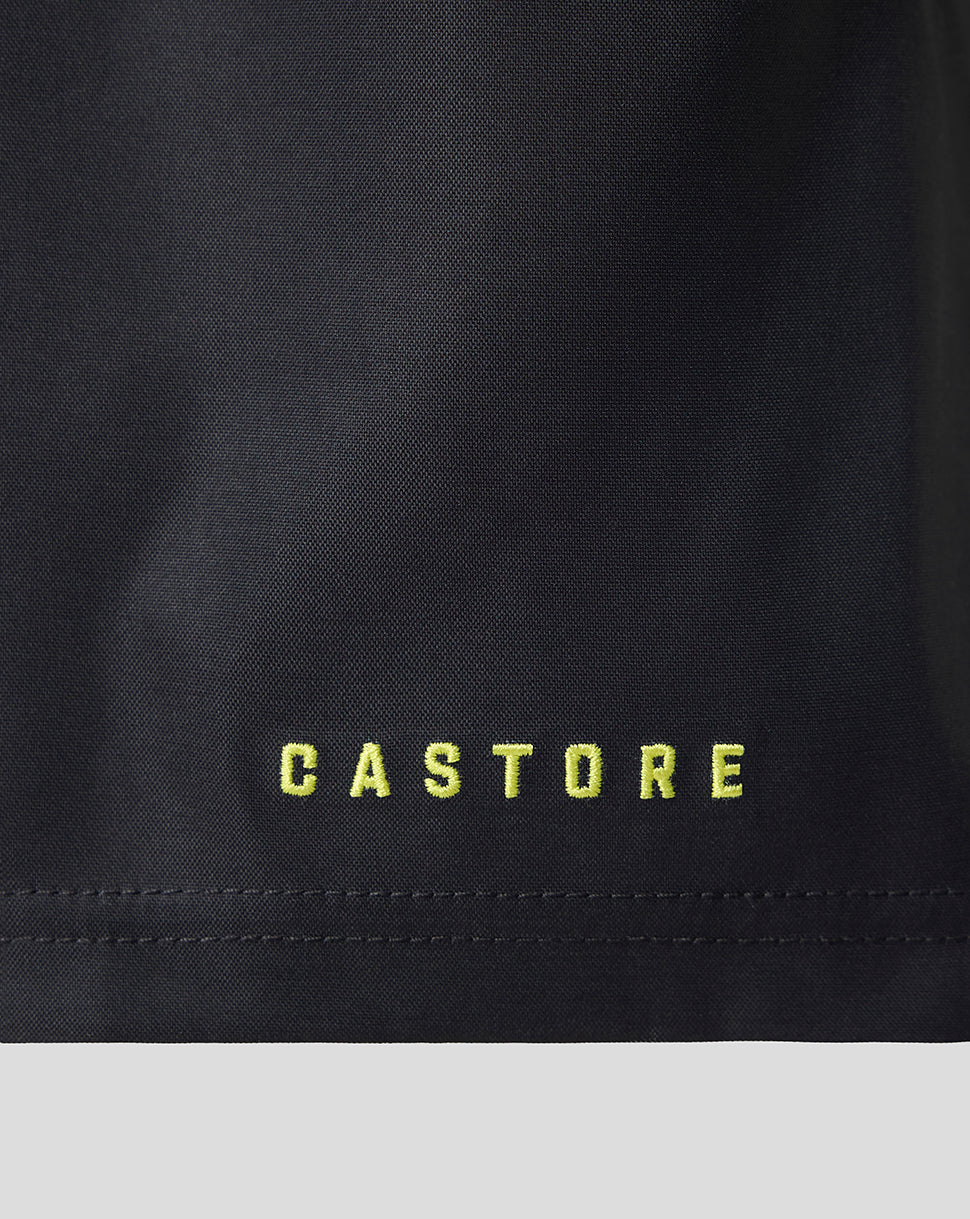 Close-up of a black garment with the brand name 'CASTORE' embroidered in bright yellow-green lettering near the hem.