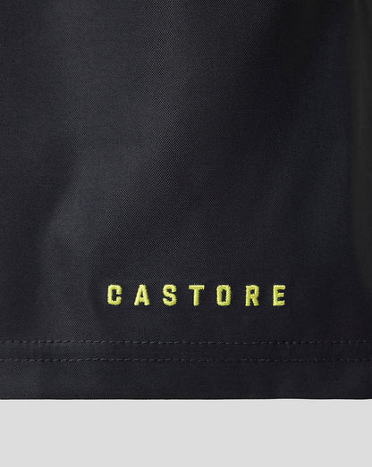 Close-up of a black garment with the brand name 'CASTORE' embroidered in bright yellow-green lettering near the hem.
