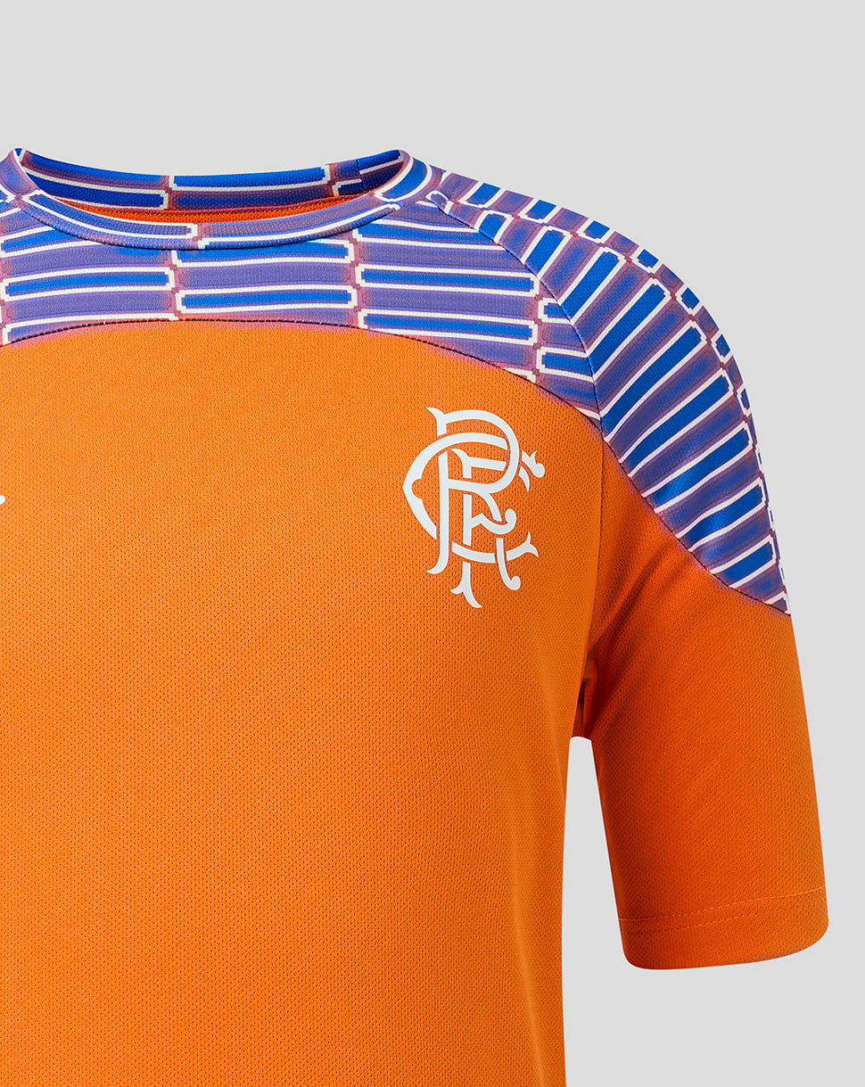 Close-up of an orange short-sleeve sports jersey with a white Rangers crest on the chest and a patterned blue and purple shoulder yoke, shown against a light gray background.