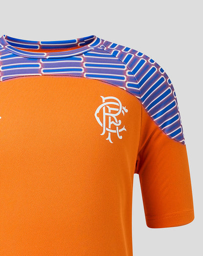 Close-up of an orange short-sleeve sports jersey with a white Rangers crest on the chest and a patterned blue and purple shoulder yoke, shown against a light gray background.