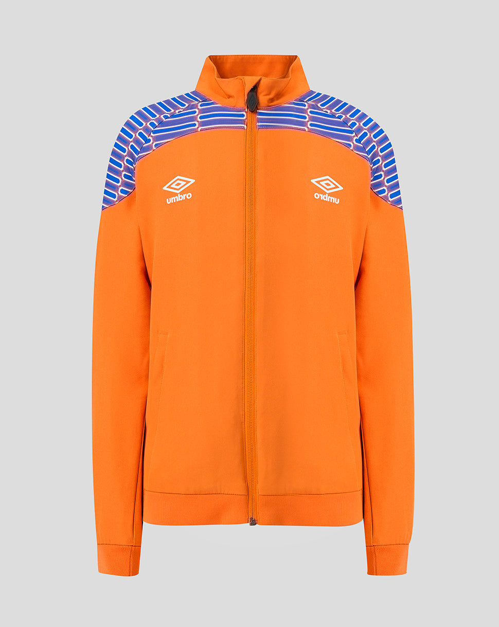 An orange full-zip track jacket with blue and white striped shoulder panels, featuring white embroidered Umbro logos on the chest, shown against a solid gray background.