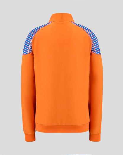 An orange long-sleeve track jacket shown from the back, featuring blue and white striped shoulder panels, on a solid gray background.