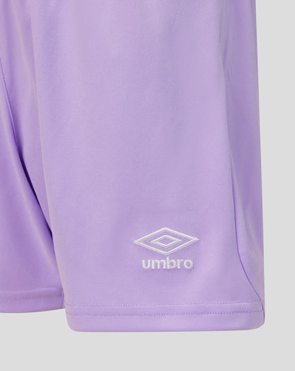 Close-up of a light purple athletic shorts leg featuring a white embroidered Umbro logo and wordmark near the hem.