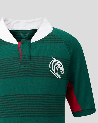 Close-up of a green rugby jersey with thin horizontal dark stripes, a white collar, a red placket accent, and a white animal head logo on the chest.