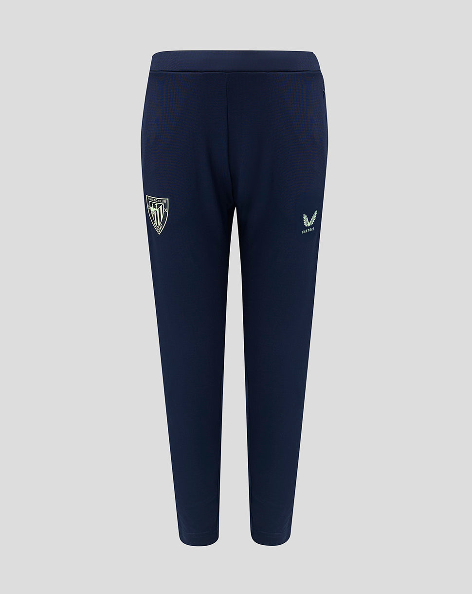 Athletic Club junior training pants in navy with crest on left leg and Castore logo on right leg