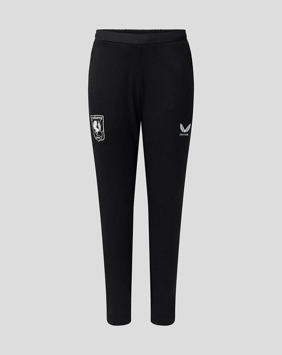 Front view of black FC Twente junior training pants with pockets, left team crest and Castore branding on the right leg.