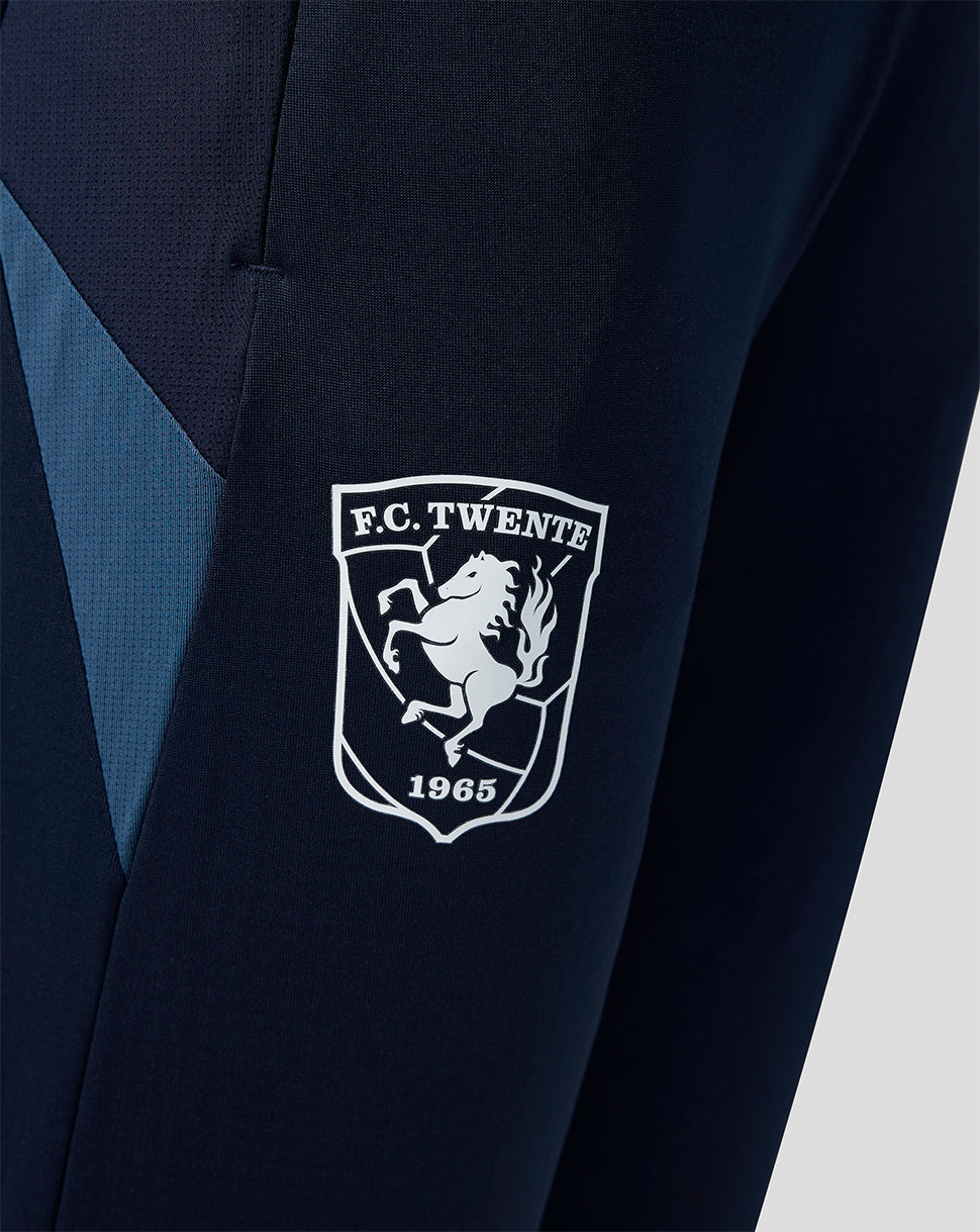 Close-up of the FC Twente crest embroidered on navy training pants