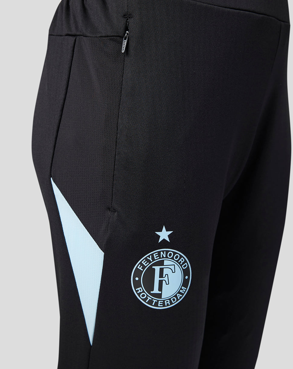 Close up of black training pants with a zip pocket and a light blue Feyenoord crest on the thigh.