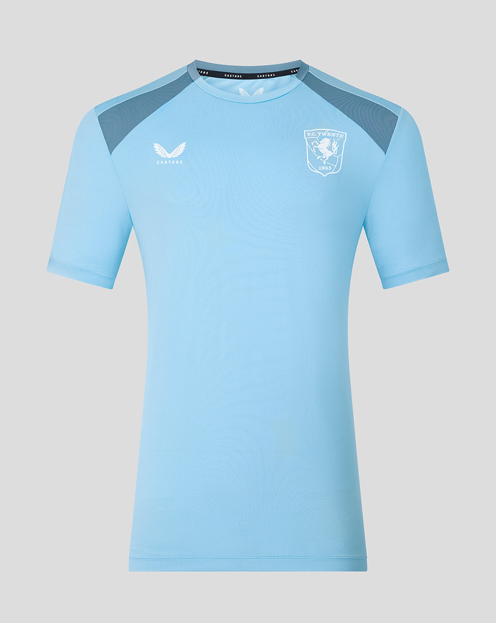 Front view of light blue FC Twente 26/27 training shirt with dark shoulder panels and club crest.