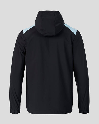 Back view of Feyenoord training rain jacket in black with light blue shoulder panels and hood