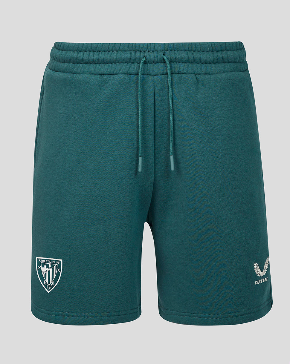 Teal men's travel shorts with drawstring waist, crest patch on the left leg and small emblem on the right.