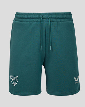 Teal men's travel shorts with drawstring waist, crest patch on the left leg and small emblem on the right.