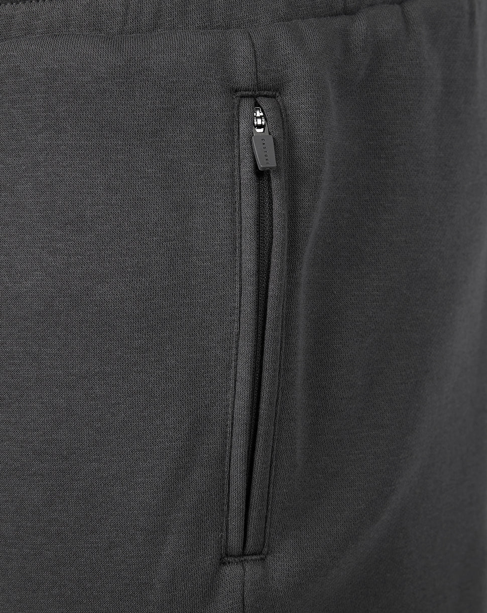 Close-up of a vertical zippered side pocket on dark gray Travel Fleece Shorts.