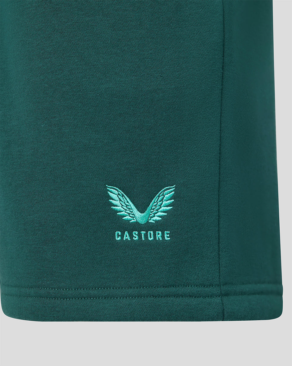 Close up of green shorts with turquoise Castore wing logo embroidery