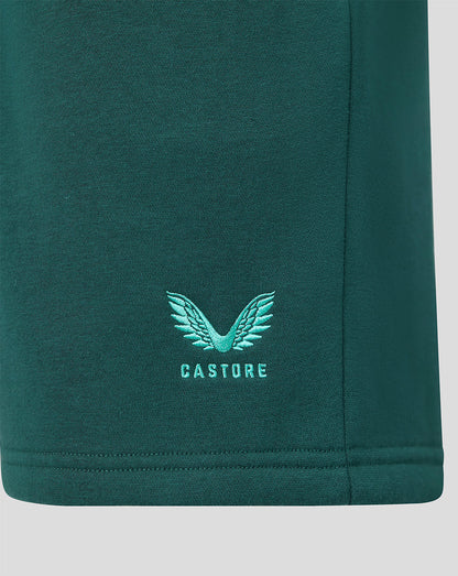 Close up of green shorts with turquoise Castore wing logo embroidery