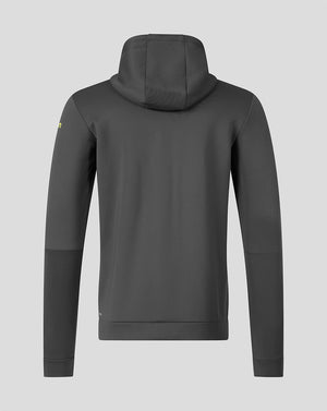 A dark gray hooded sweatshirt shown from the back, featuring a small yellow logo on the left sleeve, set against a solid light gray background.