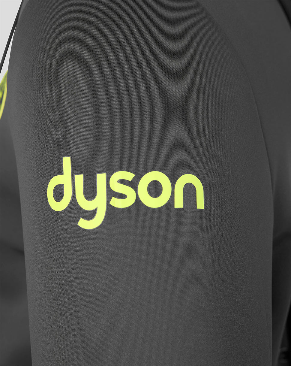Close-up of a dark gray or black athletic top with a bright yellow-green Dyson logo printed on the chest.