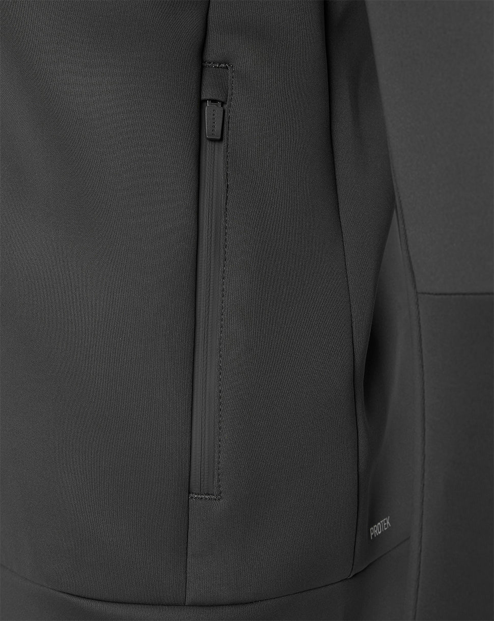 Close-up of a dark gray technical jacket fabric with a vertical zippered pocket and a small visible GORE-TEX logo near the lower right.