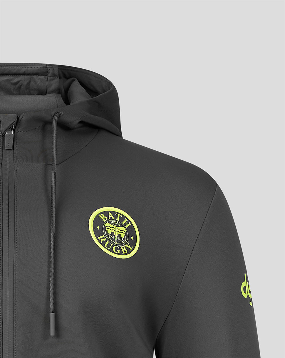 Close-up of a dark gray hooded jacket with a yellow circular 'bath Rugby' logo on the chest and a yellow logo on the sleeve, set against a light gray background.