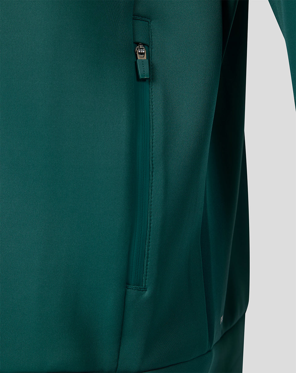 Close-up of a vertical zipper pocket on the side of the green travel hoodie.