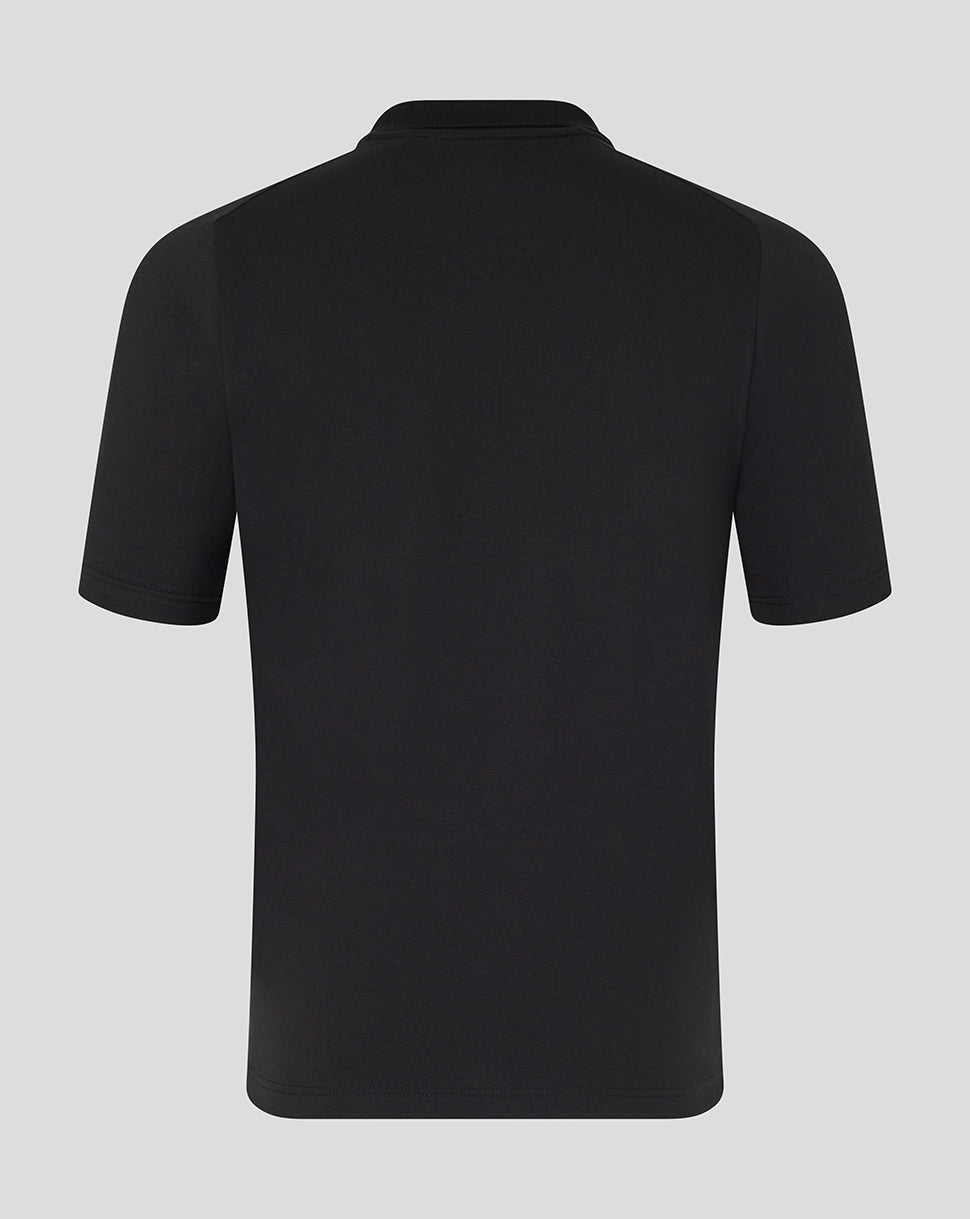 Black polo shirt on a light gray background