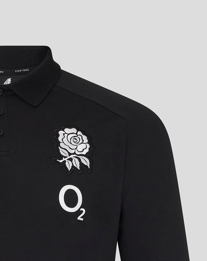 Black polo shirt with a rose emblem and 'O2' logo on a light gray background