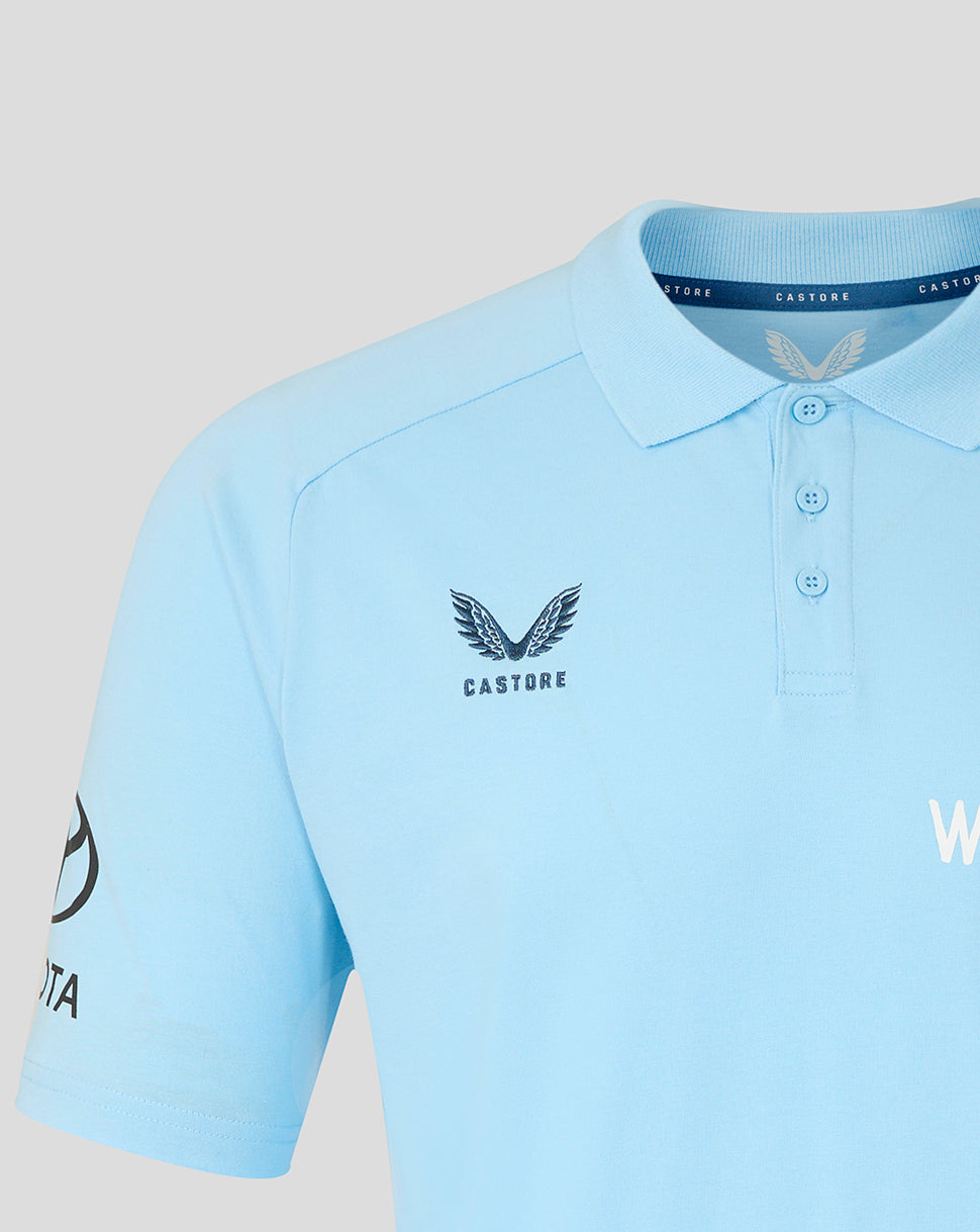 Light blue polo shirt with branding on a light gray background