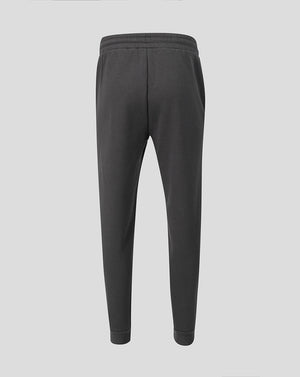 Back view of dark grey travel fleece pants with elastic waistband and Castore wing logo on the hip