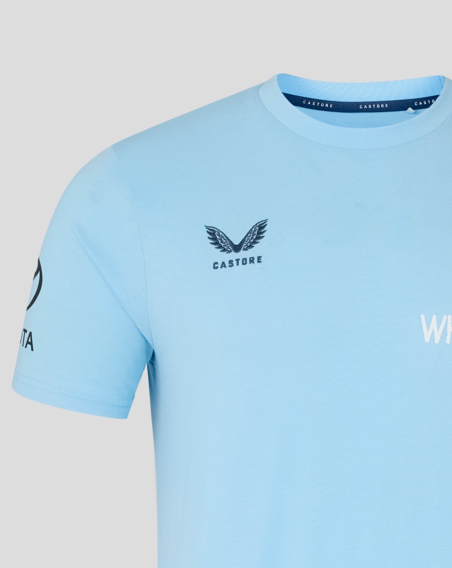 Light blue t-shirt with a logo and text on a gray background