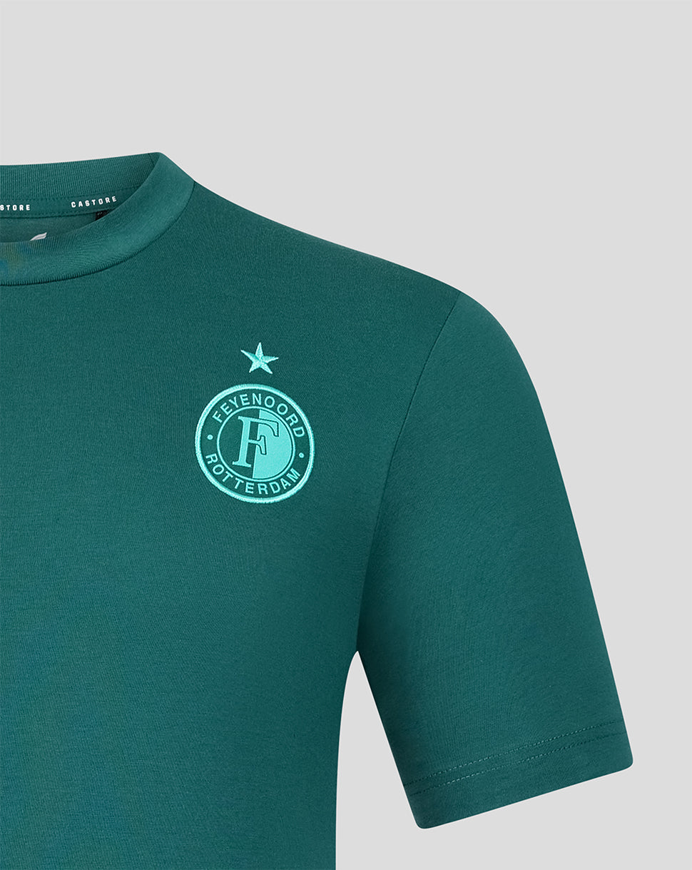 Close-up of teal Feyenoord crest and star on green travel shirt.
