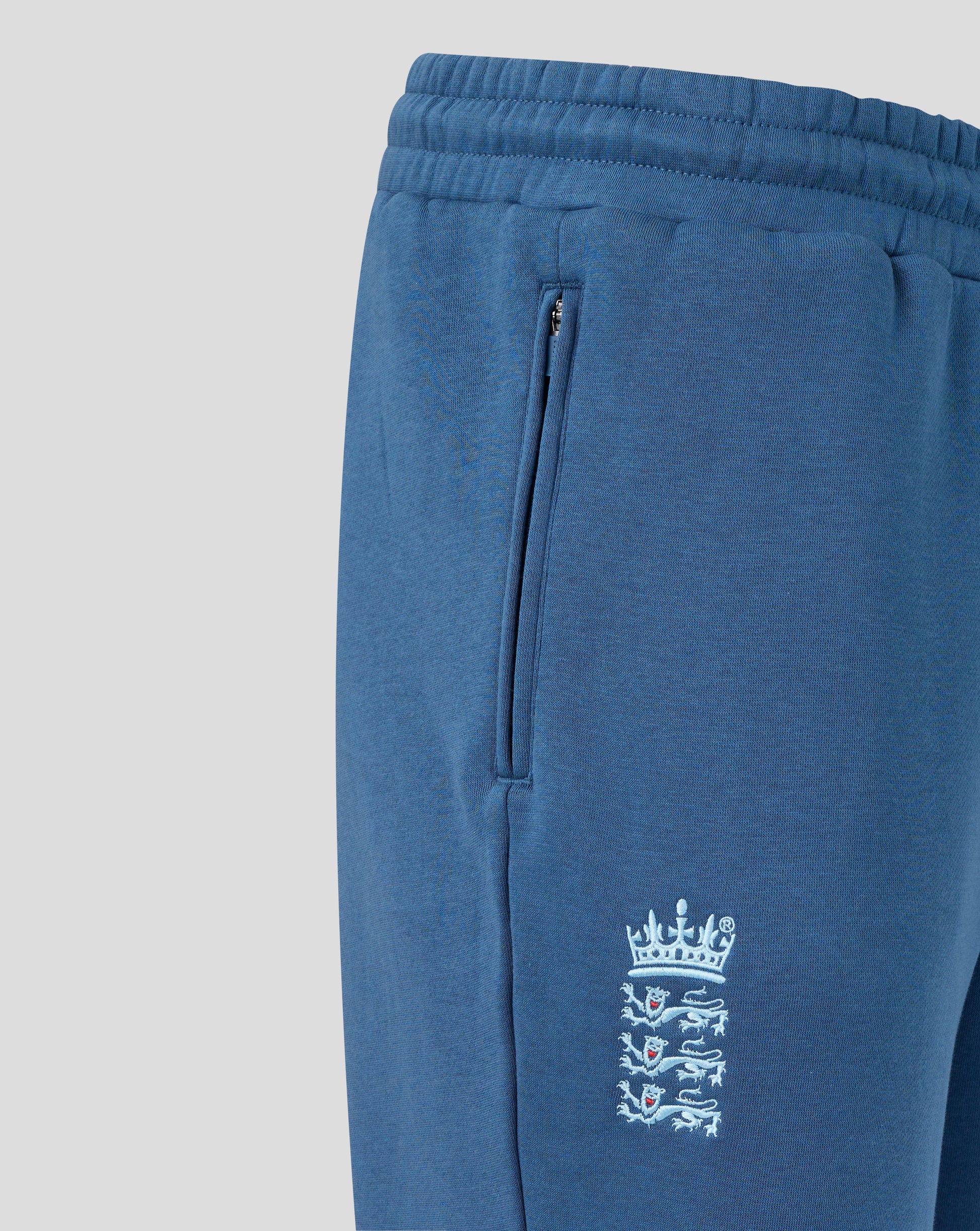 Blue sweatpants with a logo on a light gray background