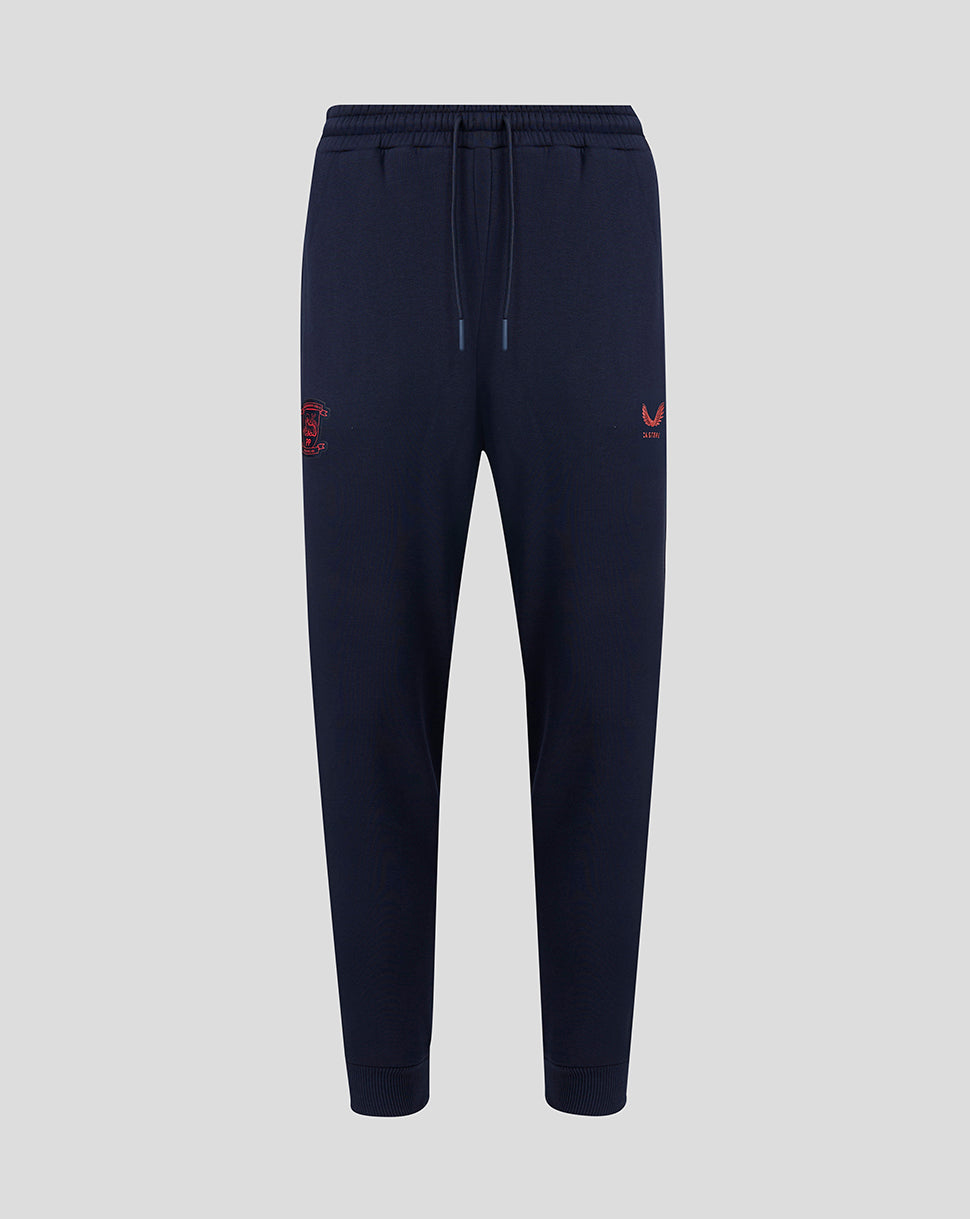 Navy blue jogger pants with red logo on a light gray background