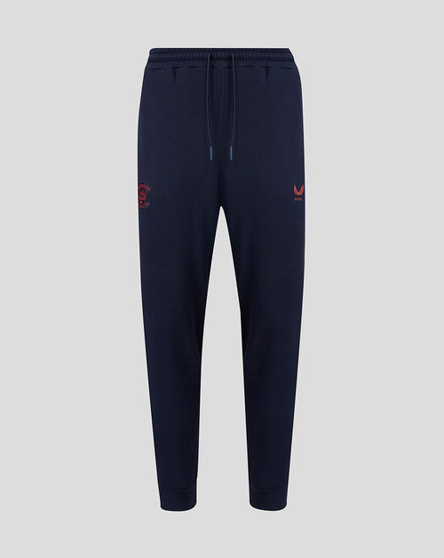Navy blue jogger pants with red logo on a light gray background