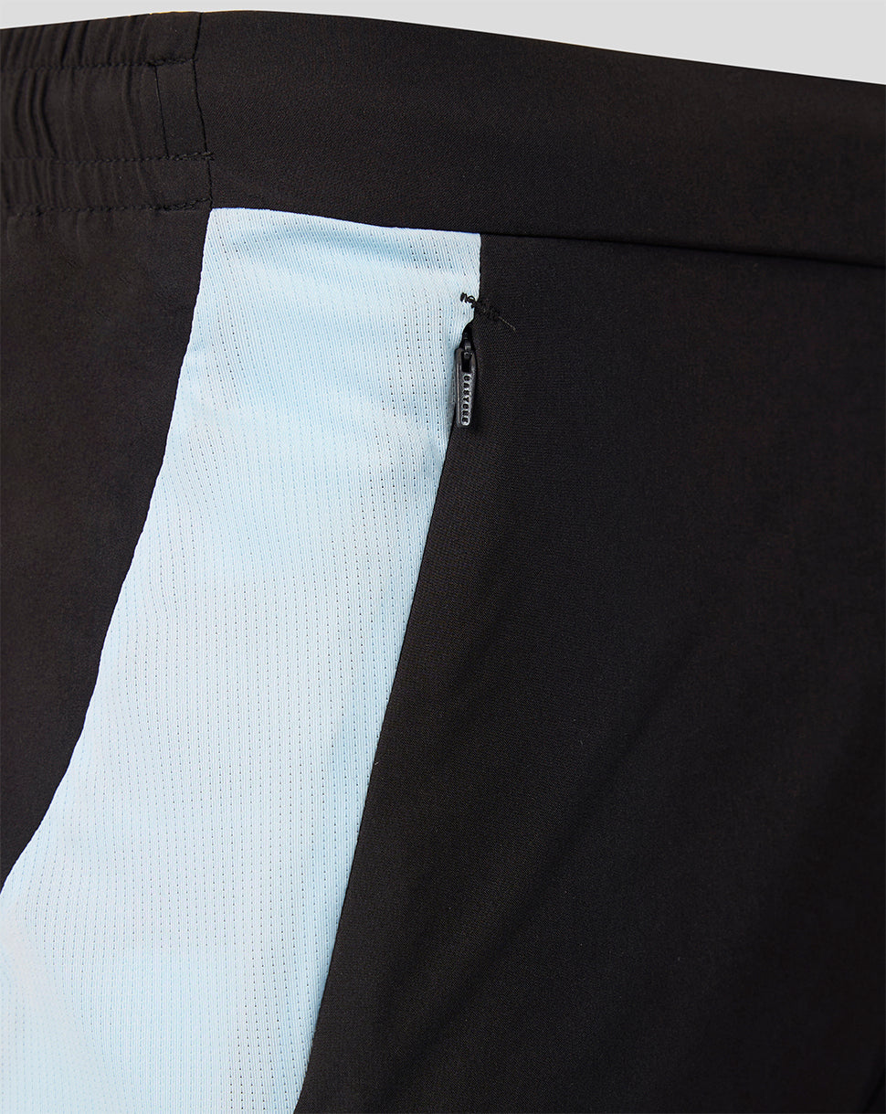 Close up of Feyenoord training shorts featuring a light blue side panel and zip pocket.