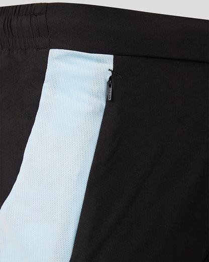Close up of Feyenoord training shorts featuring a light blue side panel and zip pocket.