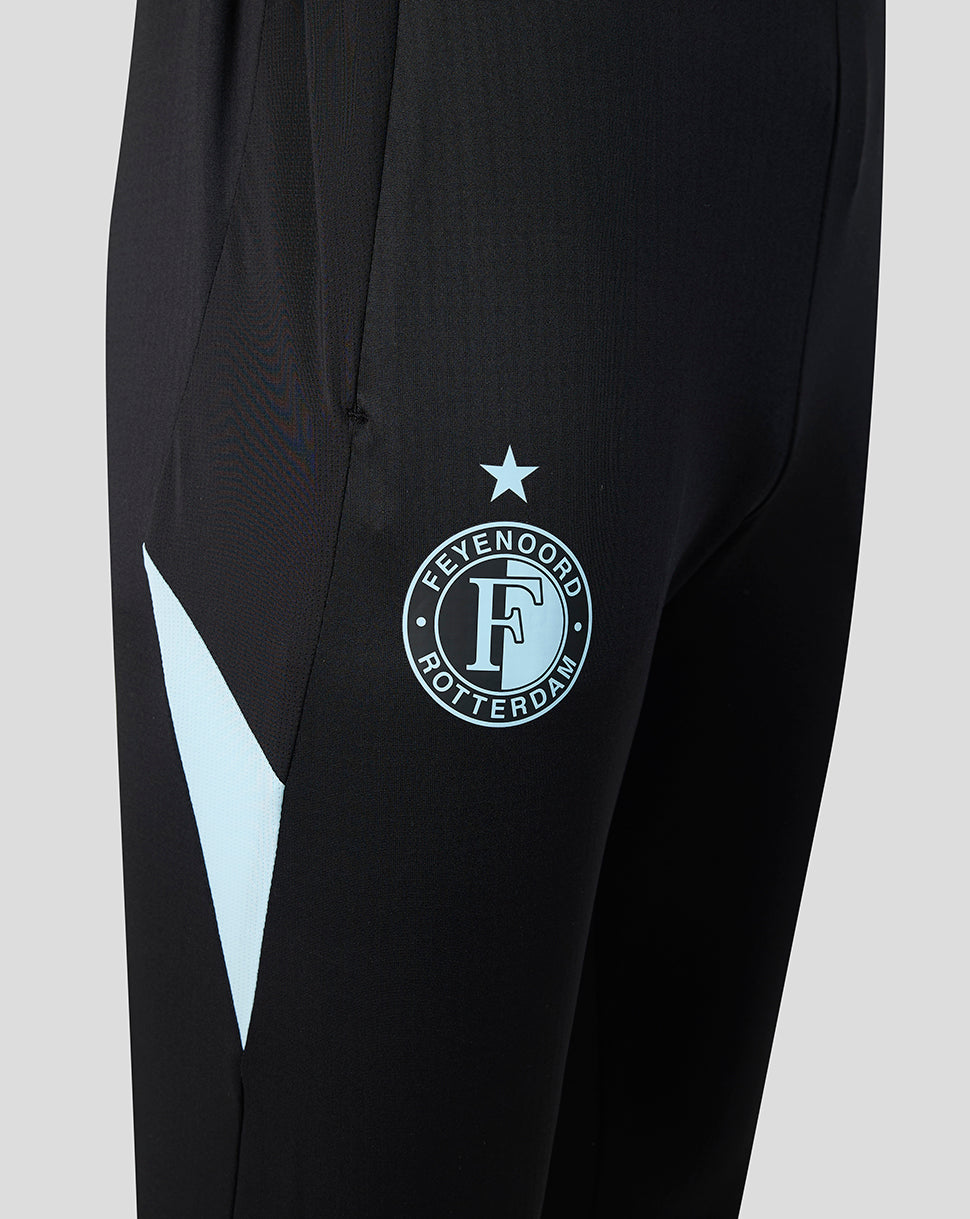Close up of the left thigh showing the Feyenoord crest and a light blue chevron detail on black fabric.