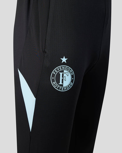 Close up of the left thigh showing the Feyenoord crest and a light blue chevron detail on black fabric.