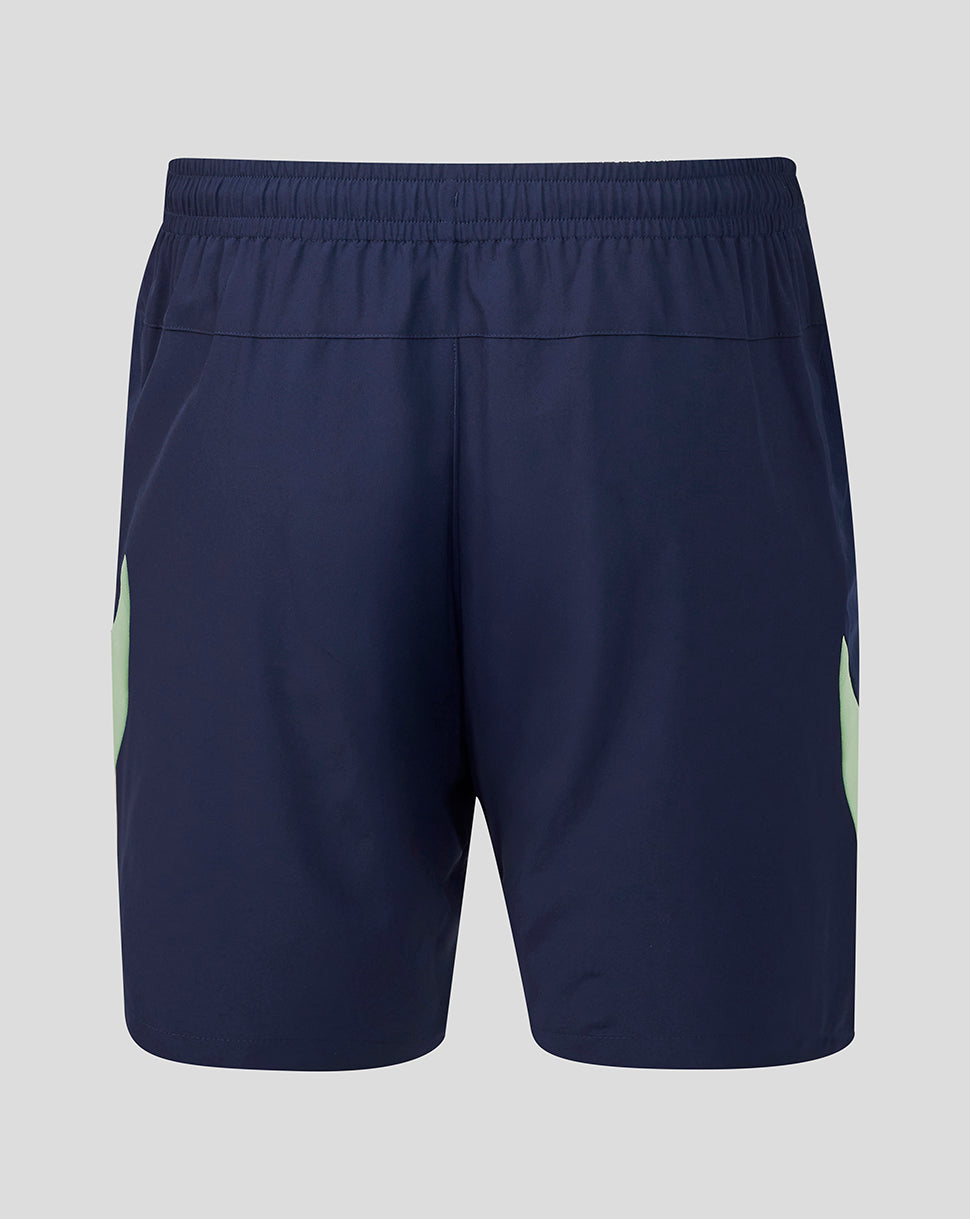 Back view of navy shorts with a mint green side panel and crest on the lower right leg