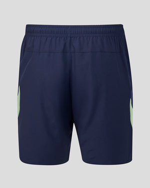 Back view of navy shorts with a mint green side panel and crest on the lower right leg