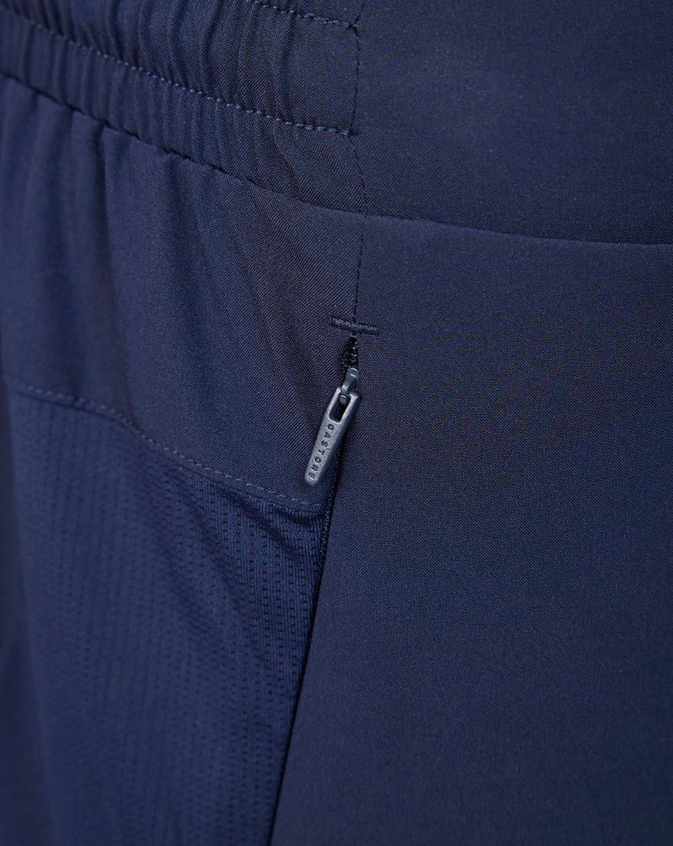 Close up of navy athletic club training shorts showing a zip side pocket and elastic waistband.