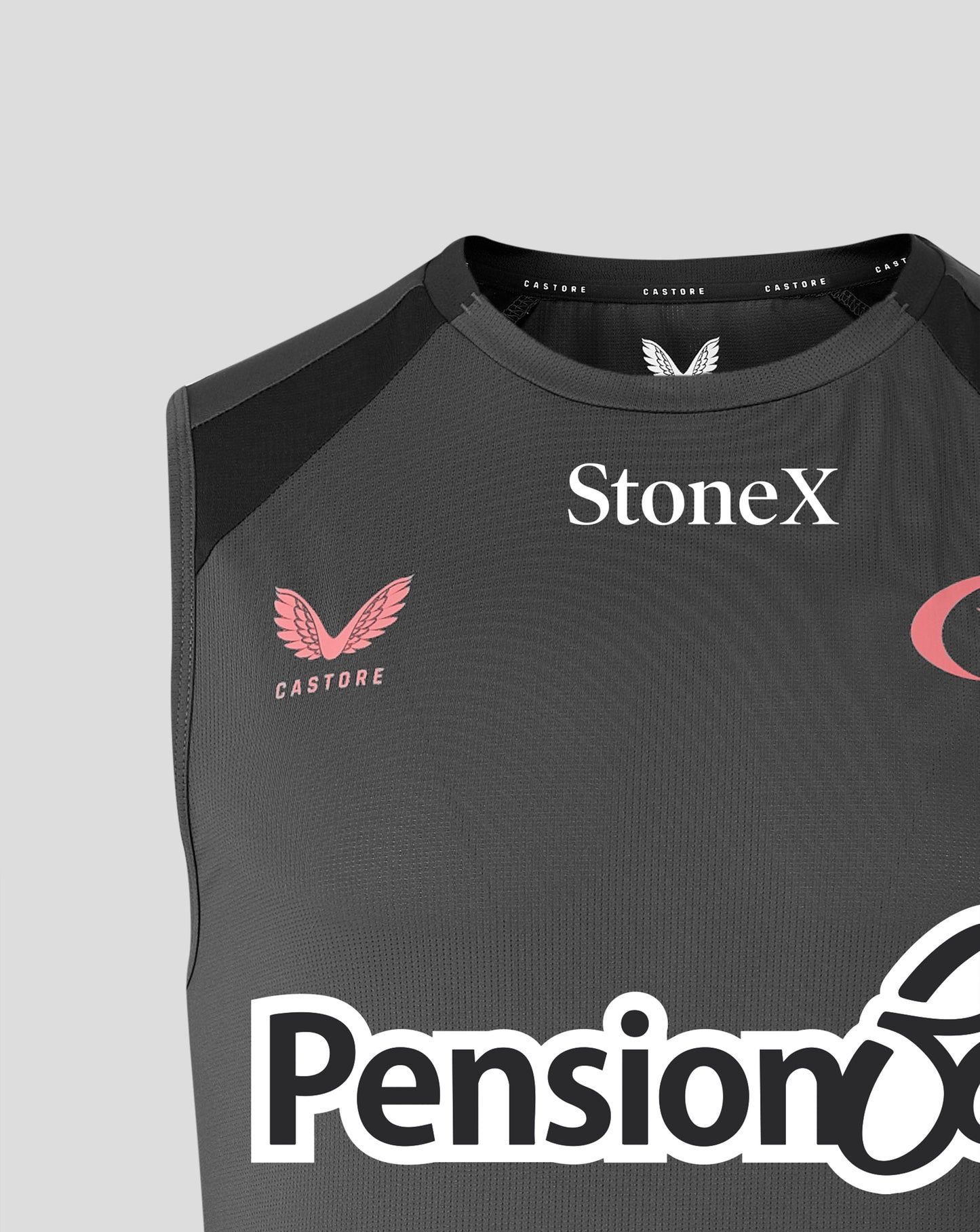 Close-up of a dark gray sleeveless athletic top with black shoulder panels, featuring the StoneX logo in white on the chest, a pink Castore wing logo, and part of the Pension6 logo at the bottom.