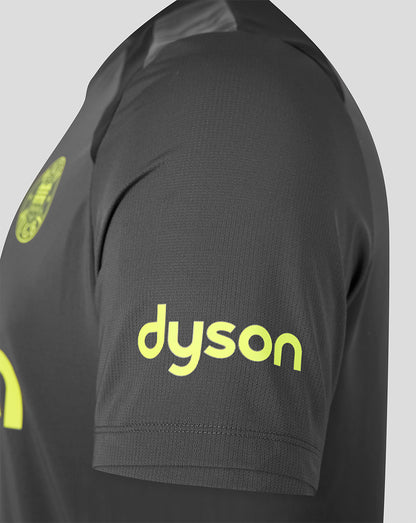 Close-up of a dark gray athletic jersey sleeve featuring a bright yellow-green 'dyson' sponsor logo on the upper arm.