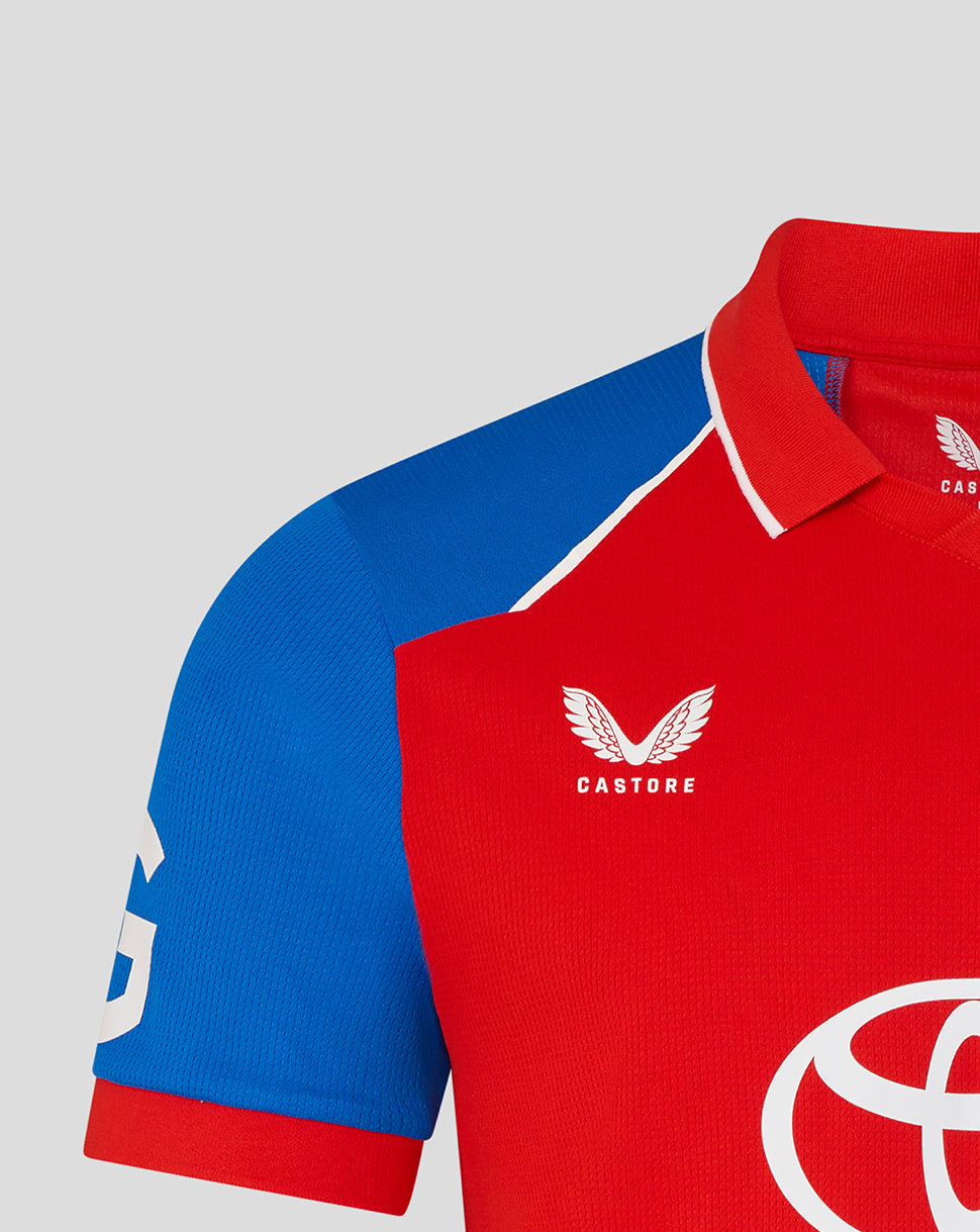 Red and blue sports jersey with 'Castore' logo on a light gray background