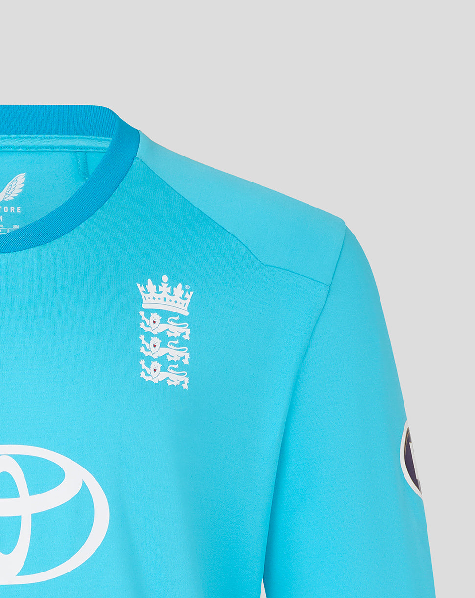 Close-up of a turquoise sports jersey with logos on a gray background