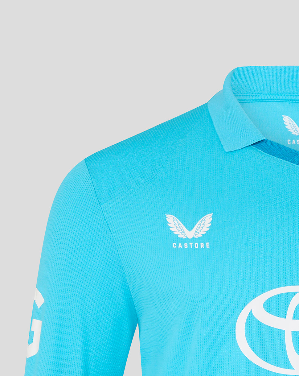 Blue athletic shirt with Castore logo on a gray background