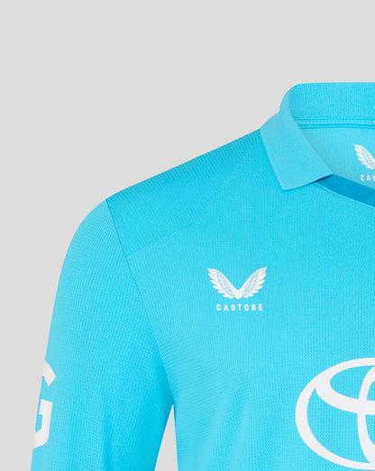 Blue athletic shirt with Castore logo on a gray background