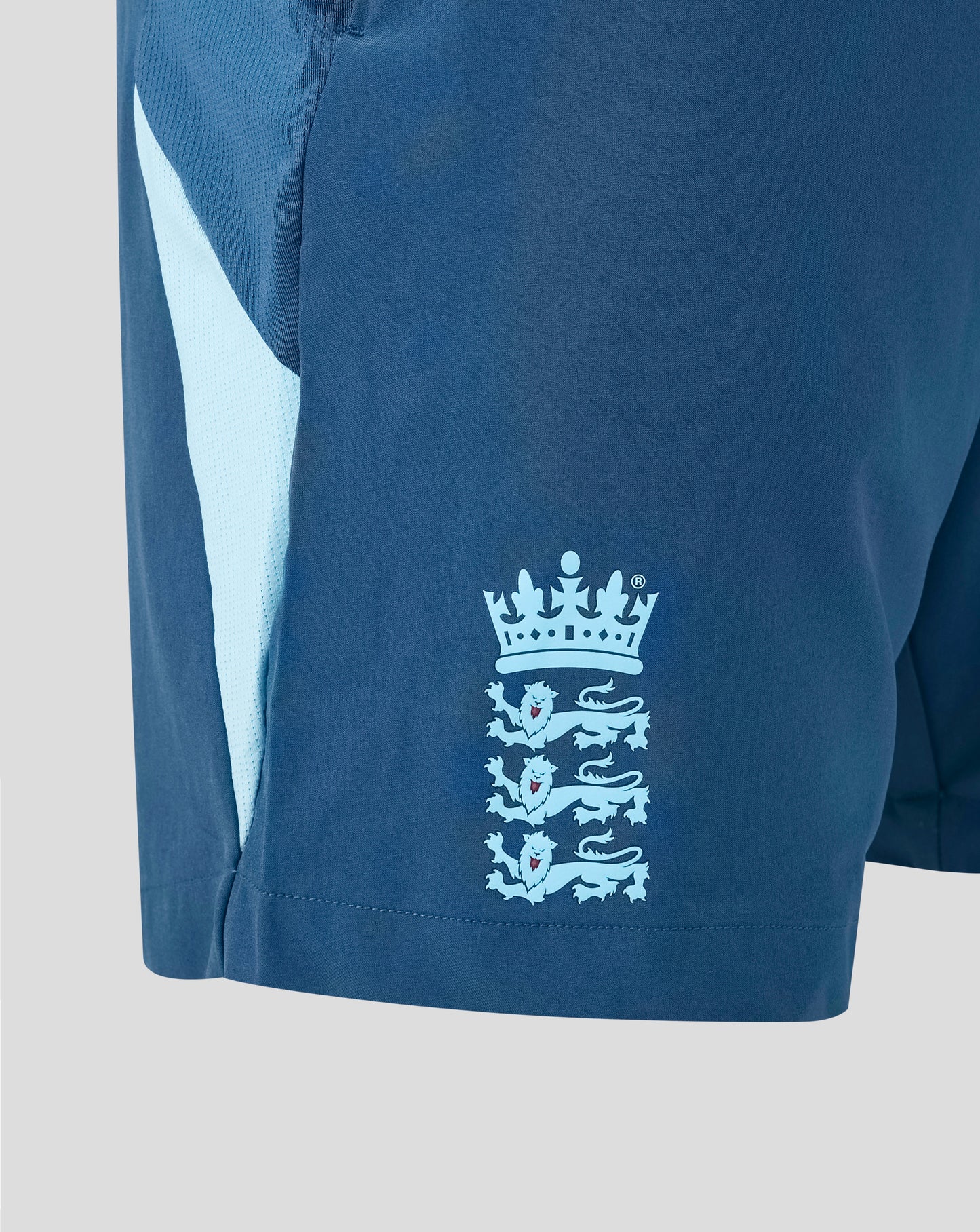 Blue sports shorts with a white logo on a light gray background