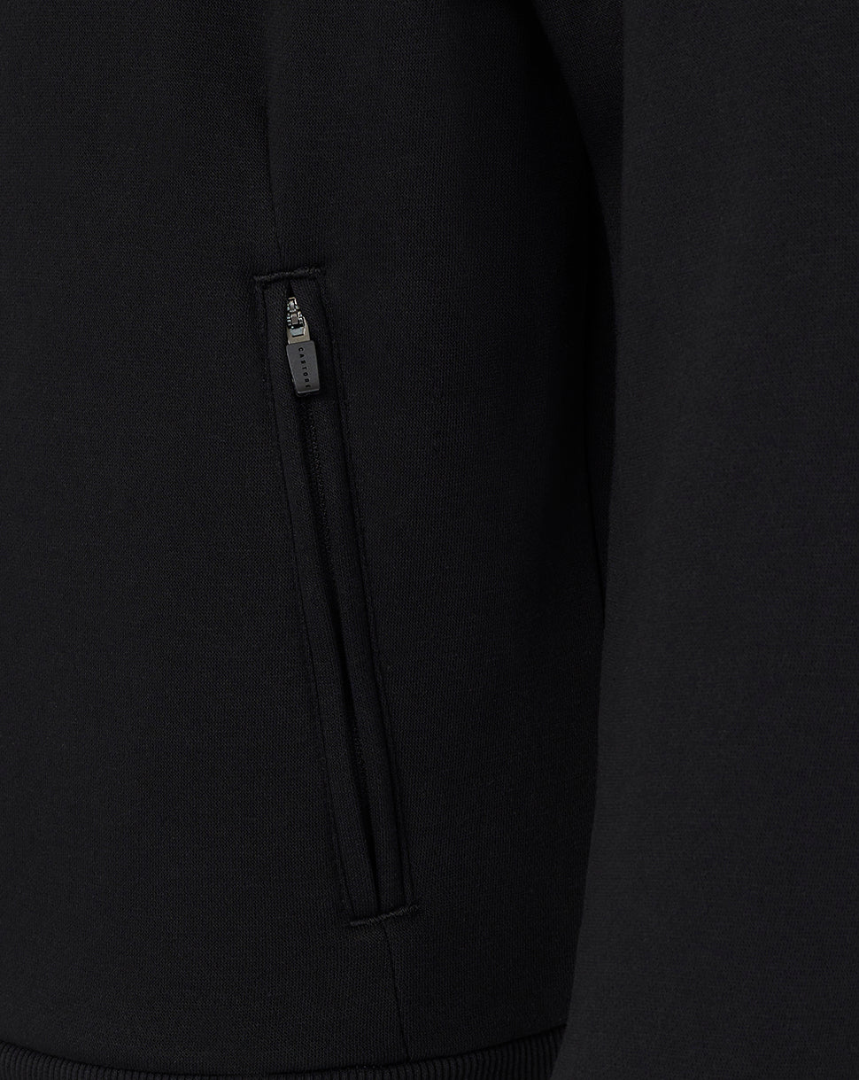 Close-up of a black hoodie with a zipper detail on a dark background