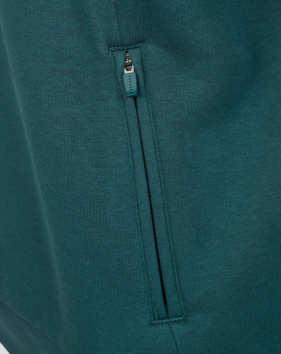 Teal green zip pocket on Athletic Club Men's Travel Hooded Sweatshirt with Castore zipper pull.