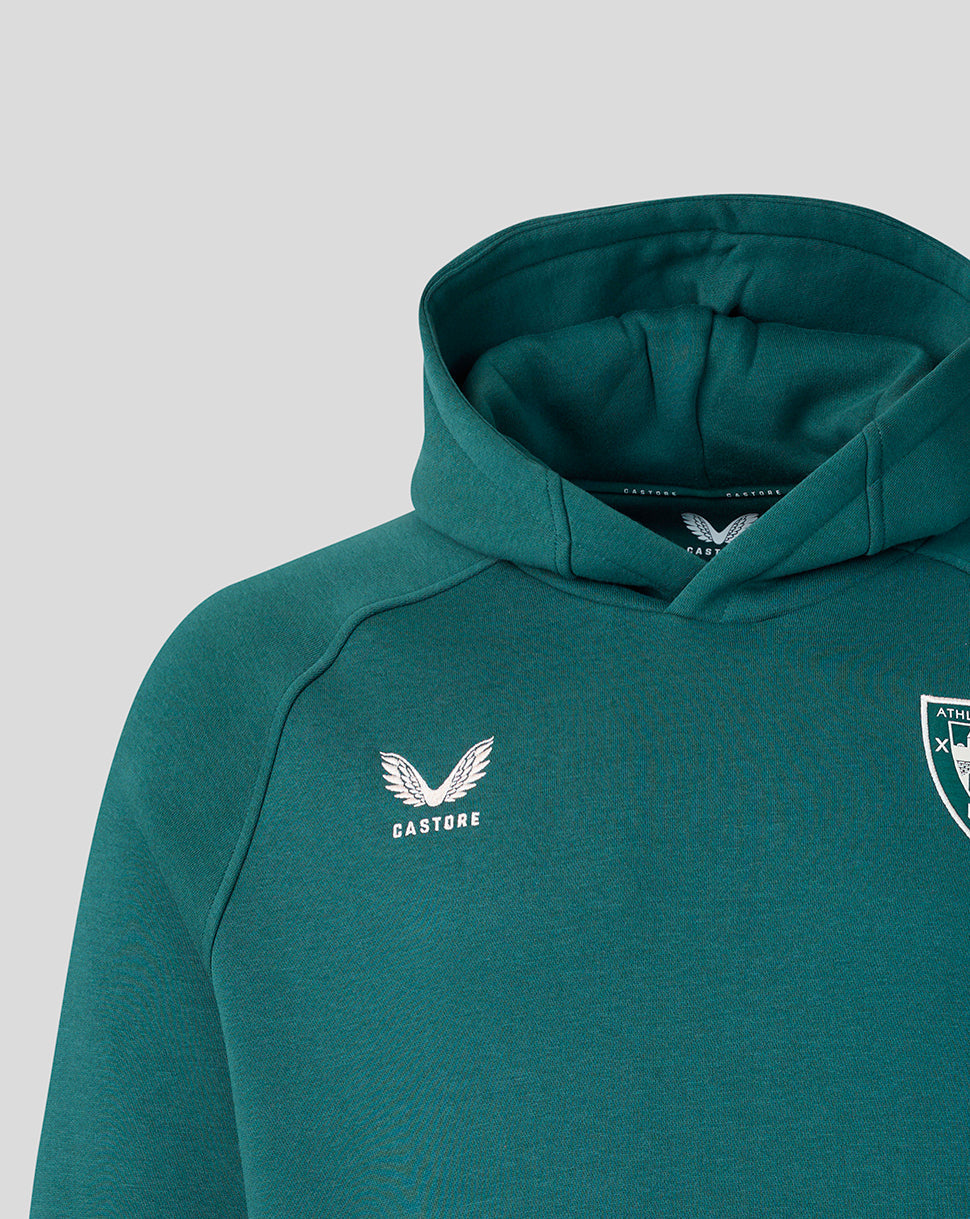 Close up of teal hoodie showing white wing logo and shield crest on the chest.